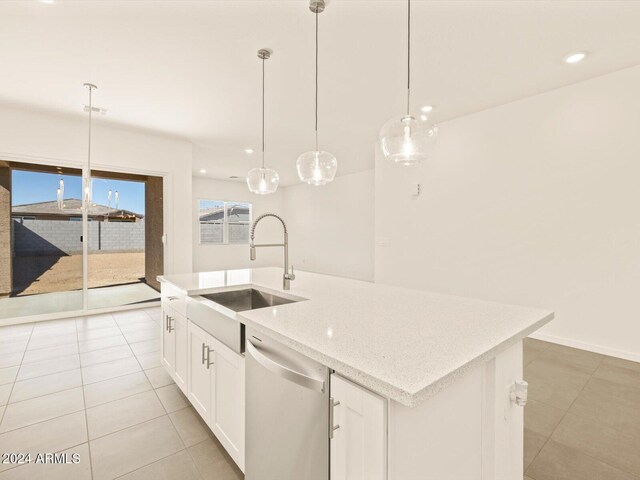 kitchen featuring sink, stainless steel dishwasher, hanging light fixtures, an island with sink, and white cabinets