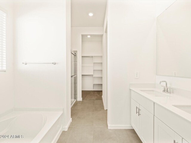 bathroom featuring vanity, tile patterned flooring, and separate shower and tub