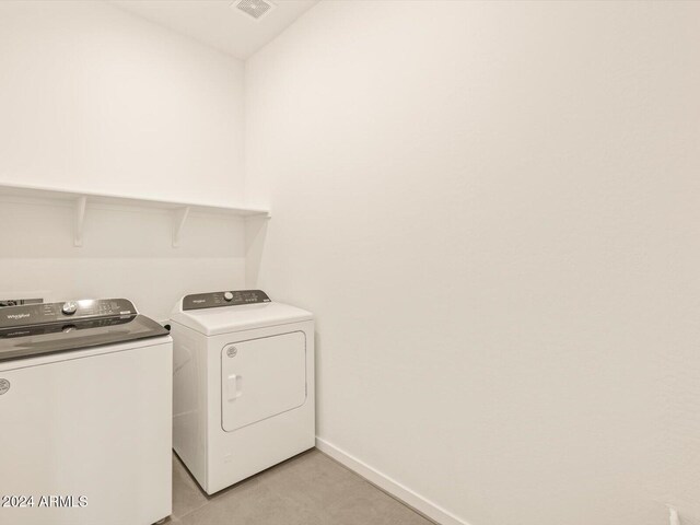 washroom with washing machine and clothes dryer