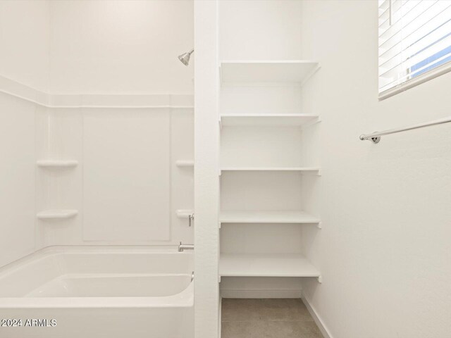 bathroom with tile patterned floors and shower / bathing tub combination