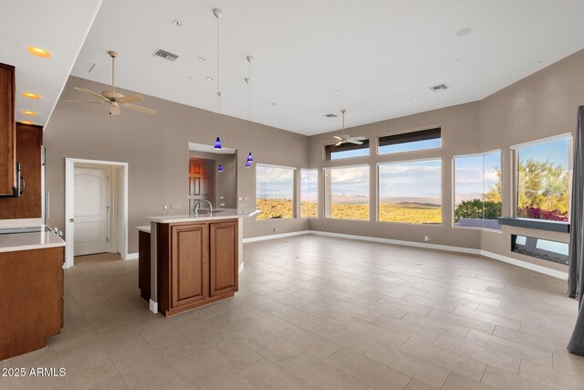 16814 N Boulder Dr, Fountain Hills, AZ 85268 - kitchen featuring a ceiling fan, a high ceiling, open floor plan, light countertops, and plenty of natural light