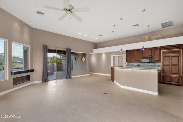 16814 N Boulder Dr, Fountain Hills, AZ 85268 - kitchen with black microwave, a ceiling fan, open floor plan, light countertops, and a high ceiling