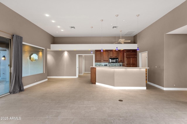16814 N Boulder Dr, Fountain Hills, AZ 85268 - kitchen featuring black microwave, a high ceiling, baseboards, light countertops, and open floor plan