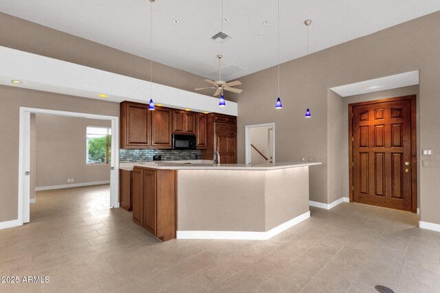 16814 N Boulder Dr, Fountain Hills, AZ 85268 - kitchen with black microwave, brown cabinetry, baseboards, light countertops, and decorative light fixtures