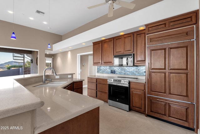 16814 N Boulder Dr, Fountain Hills, AZ 85268 - kitchen featuring electric range, black microwave, a sink, paneled built in fridge, and decorative backsplash