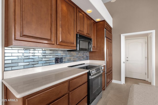16814 N Boulder Dr, Fountain Hills, AZ 85268 - kitchen with stainless steel range with electric cooktop, black microwave, tasteful backsplash, light countertops, and light tile patterned flooring
