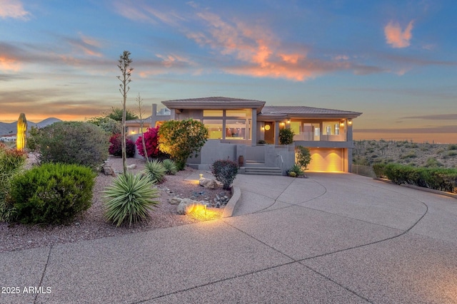 16814 N Boulder Dr, Fountain Hills, AZ 85268 - prairie-style home featuring curved driveway, an attached garage, covered porch, stucco siding, and stairs
