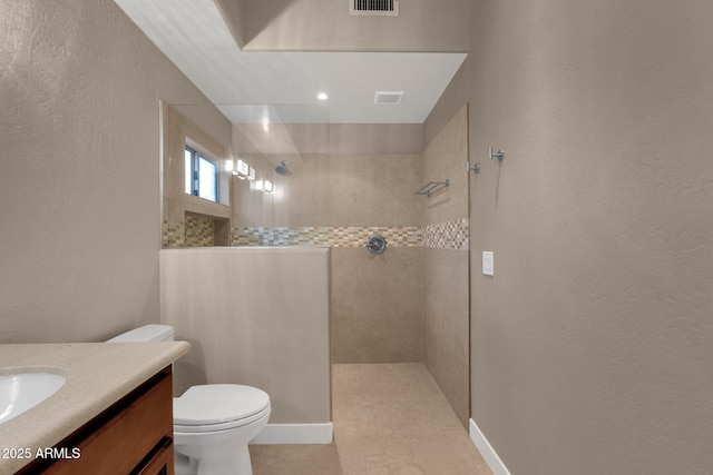 16814 N Boulder Dr, Fountain Hills, AZ 85268 - bathroom featuring a walk in shower, a textured wall, toilet, vanity, and baseboards