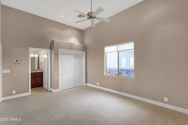16814 N Boulder Dr, Fountain Hills, AZ 85268 - unfurnished bedroom with a towering ceiling, baseboards, a closet, ensuite bath, and a sink