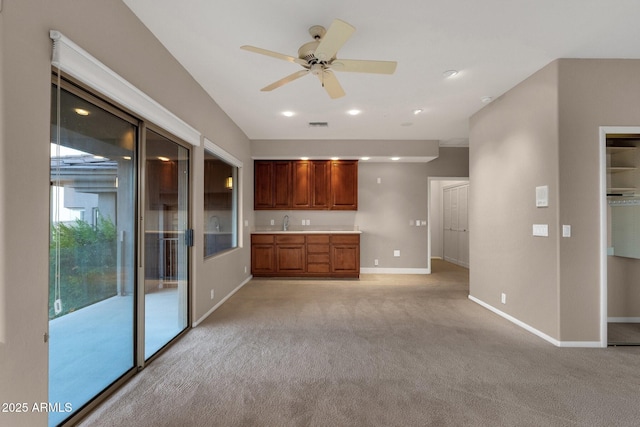 16814 N Boulder Dr, Fountain Hills, AZ 85268 - unfurnished living room with light carpet, baseboards, ceiling fan, recessed lighting, and a sink