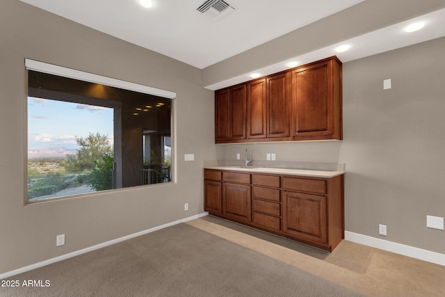 16814 N Boulder Dr, Fountain Hills, AZ 85268 - kitchen with recessed lighting, light countertops, baseboards, brown cabinetry, and a sink