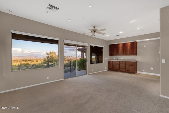16814 N Boulder Dr, Fountain Hills, AZ 85268 - unfurnished living room with baseboards, light carpet, ceiling fan, a sink, and recessed lighting
