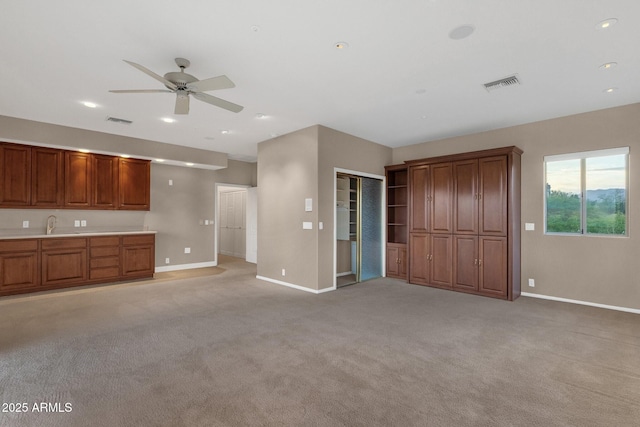 16814 N Boulder Dr, Fountain Hills, AZ 85268 - unfurnished living room with baseboards, ceiling fan, light colored carpet, recessed lighting, and a sink
