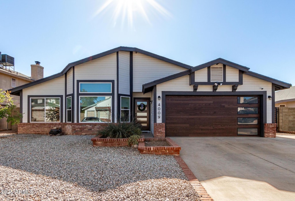 view of front of property with central AC unit and a garage