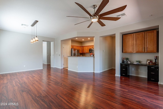 unfurnished living room featuring ceiling fan and dark wood-type flooring