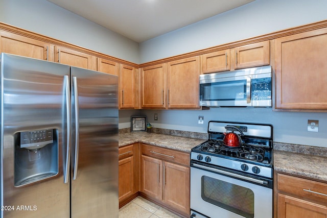 kitchen featuring appliances with stainless steel finishes and light tile patterned floors