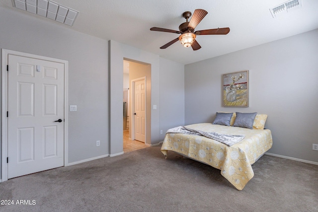 bedroom featuring light colored carpet and ceiling fan