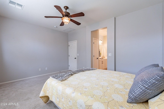 bedroom featuring ensuite bathroom, ceiling fan, and carpet