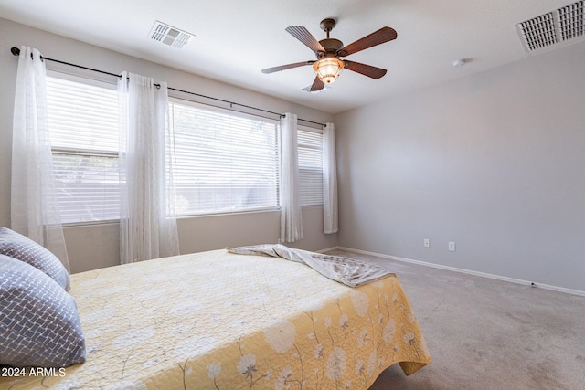 bedroom with ceiling fan and carpet floors