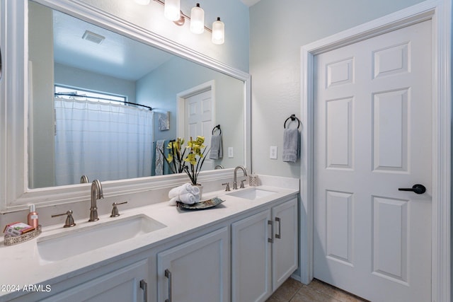 bathroom featuring walk in shower, vanity, and tile patterned flooring