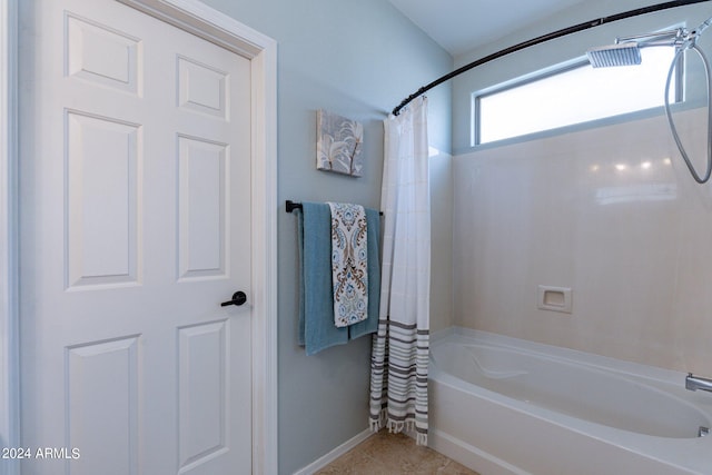 bathroom featuring shower / bathtub combination with curtain