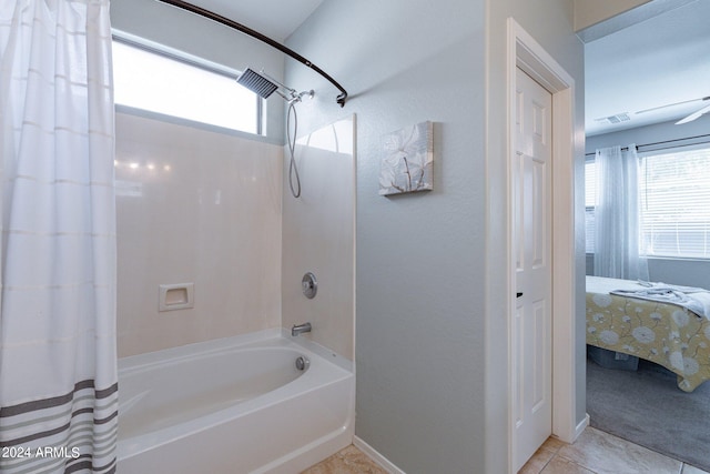 bathroom with tile patterned floors and shower / bath combo with shower curtain