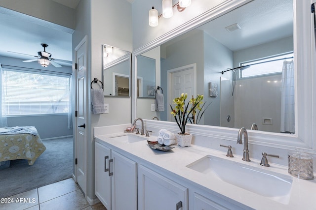 bathroom featuring a shower with curtain, vanity, tile patterned flooring, and a healthy amount of sunlight