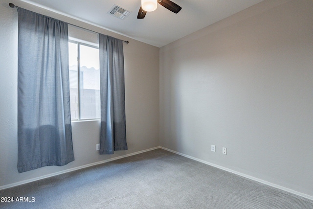 carpeted empty room featuring ceiling fan