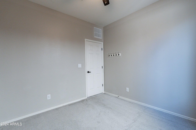 empty room with light carpet and ceiling fan