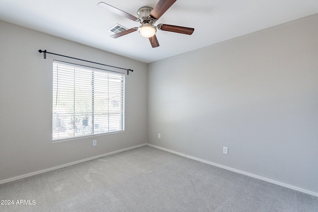 carpeted spare room with ceiling fan