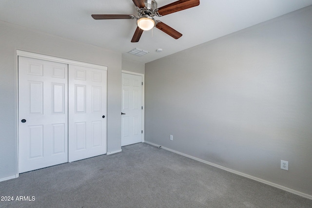 unfurnished bedroom featuring a closet, carpet, and ceiling fan