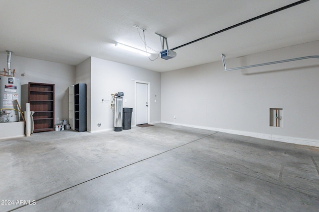 garage featuring gas water heater and a garage door opener