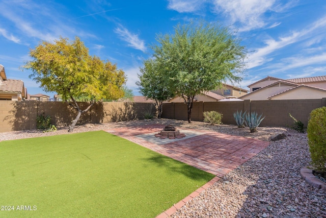 view of yard with an outdoor fire pit and a patio area