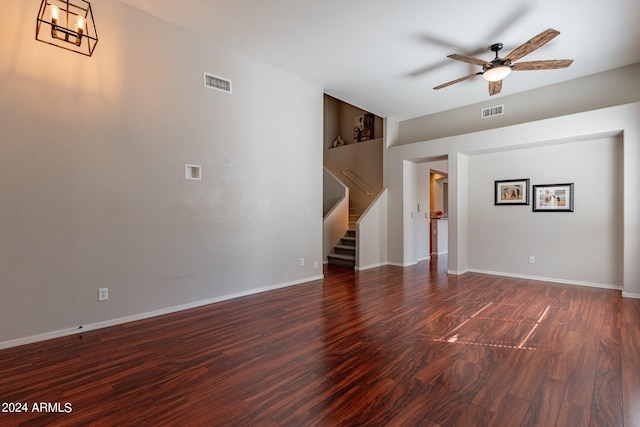 unfurnished living room featuring dark wood-type flooring, built in features, and ceiling fan