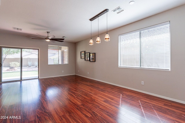 unfurnished room featuring dark hardwood / wood-style flooring and ceiling fan