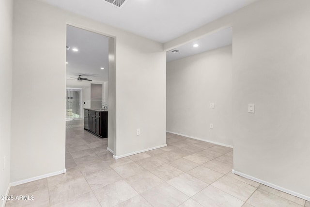 tiled empty room with sink and ceiling fan