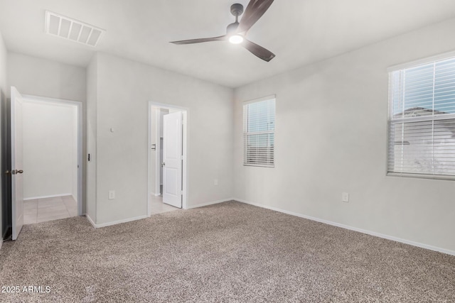 unfurnished bedroom featuring multiple windows, light carpet, and ceiling fan