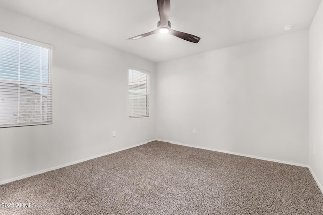 carpeted spare room with ceiling fan