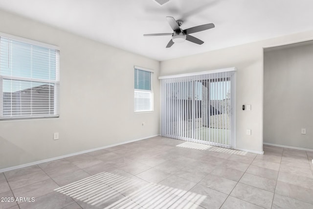 tiled spare room with ceiling fan