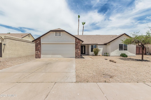 11021 N 55th Dr, Glendale, AZ 85304 - view of front facade featuring a garage, concrete driveway, stucco siding, and brick siding