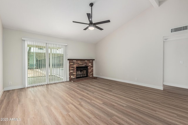 11021 N 55th Dr, Glendale, AZ 85304 - unfurnished living room with a ceiling fan, wood finished floors, baseboards, a brick fireplace, and high vaulted ceiling