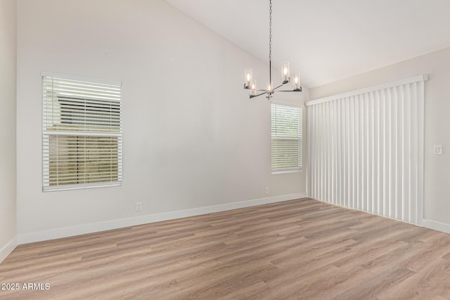 11021 N 55th Dr, Glendale, AZ 85304 - unfurnished room featuring a chandelier, light wood finished floors, high vaulted ceiling, and baseboards