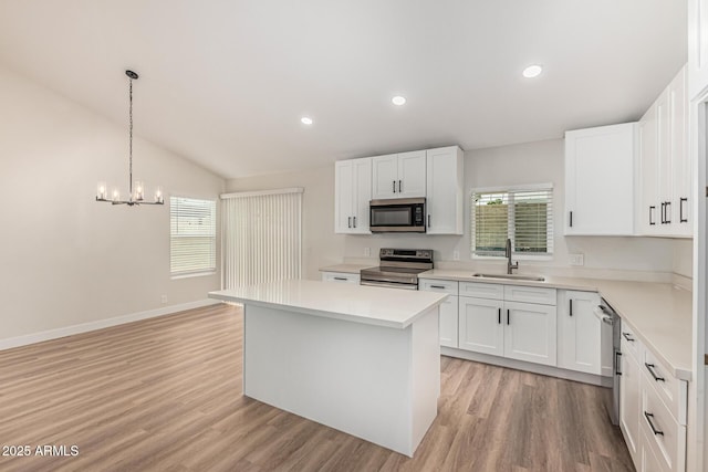 11021 N 55th Dr, Glendale, AZ 85304 - kitchen with appliances with stainless steel finishes, a sink, plenty of natural light, a center island, and vaulted ceiling