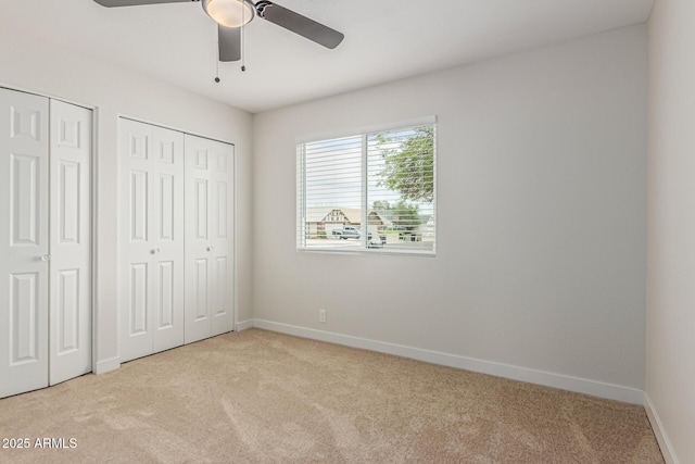 11021 N 55th Dr, Glendale, AZ 85304 - unfurnished bedroom with two closets, carpet floors, and baseboards