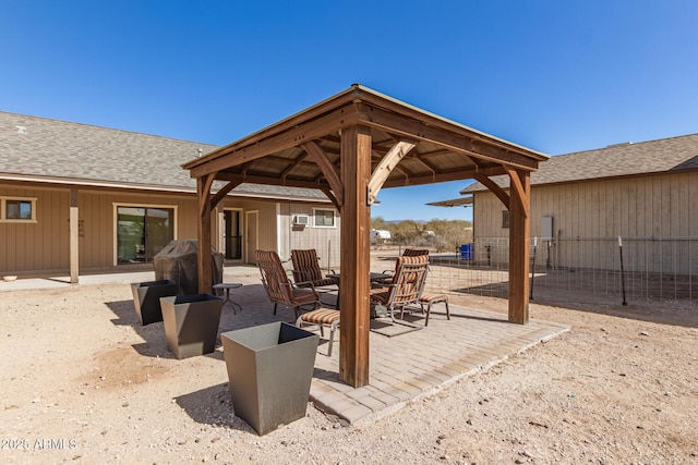 view of patio / terrace featuring a grill, fence, and a gazebo