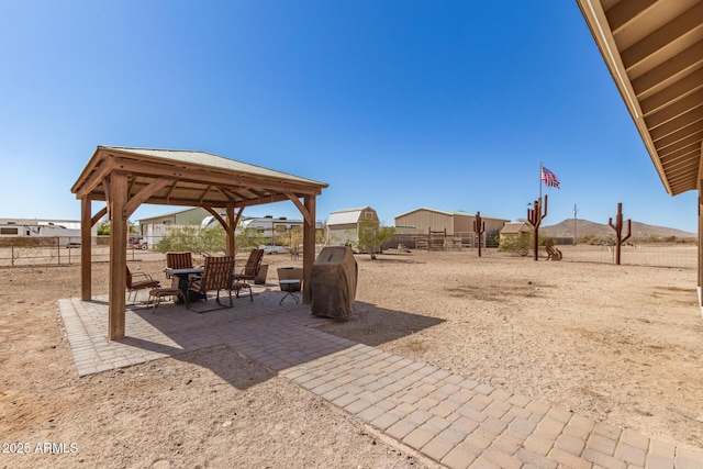 view of yard featuring fence, a patio, and a gazebo