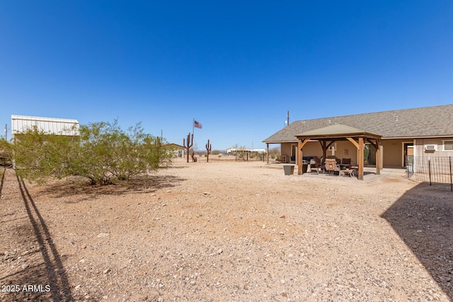 view of yard featuring a patio area, fence, and a gazebo