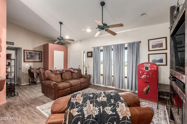 living area featuring lofted ceiling, wood finished floors, visible vents, and a ceiling fan