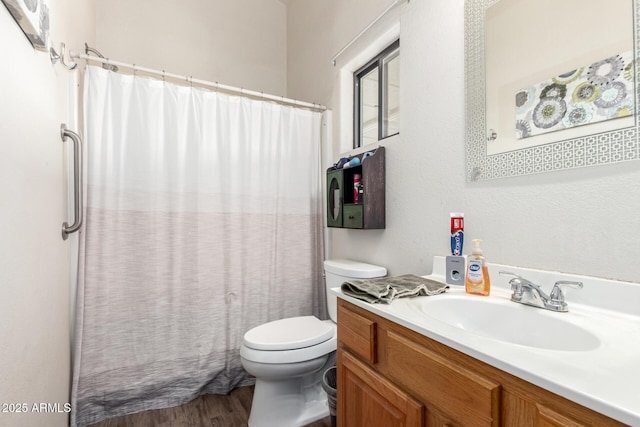 bathroom featuring toilet, wood finished floors, a shower with shower curtain, and vanity