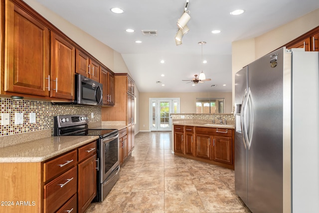 kitchen featuring tasteful backsplash, ceiling fan, stainless steel appliances, lofted ceiling, and pendant lighting